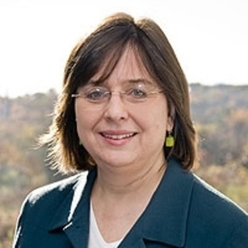 white woman with short brown hair and glasses