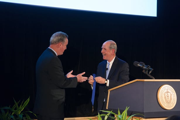 Special Representative for Global Partnerships in the U.S. Secretary of State’s Office Drew O’Brien receives a surprise chancellor’s medal from Chancellor Michael F. Collins.