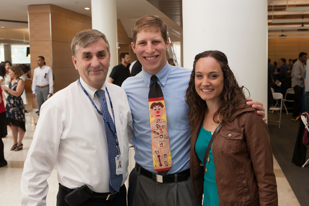 SOM graduate Jonathan William Smits (center) with Michael Kneeland, MD, and fiancé Julie Licata