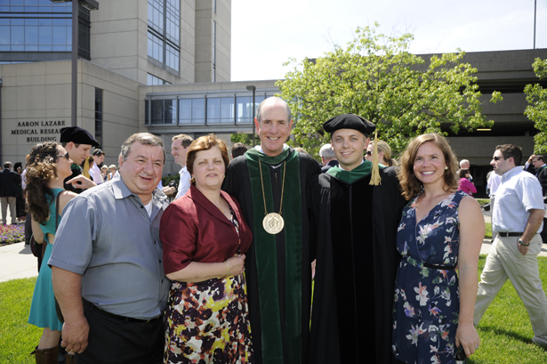SOM graduate Dimas Espinola (second from right) with (from left) parents Ray and Mary Kay Espinola, Chancellor Collins and wife Ali Turro.
