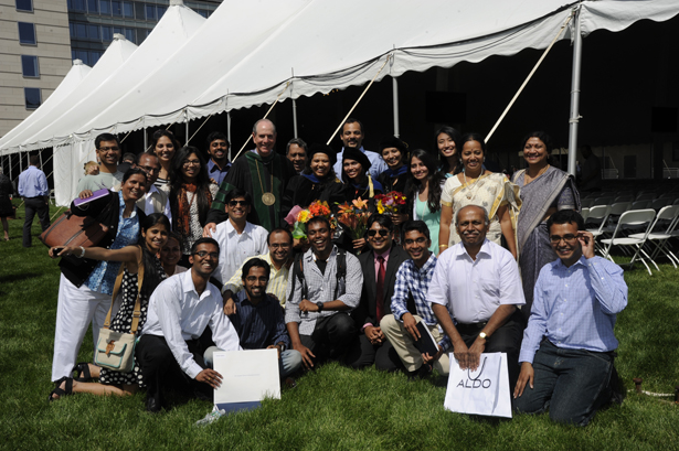 Sandhya Ganesan, Ankita Bansal and Sneha Gupta with their friends and family, and Chancellor Michael F. Collins.