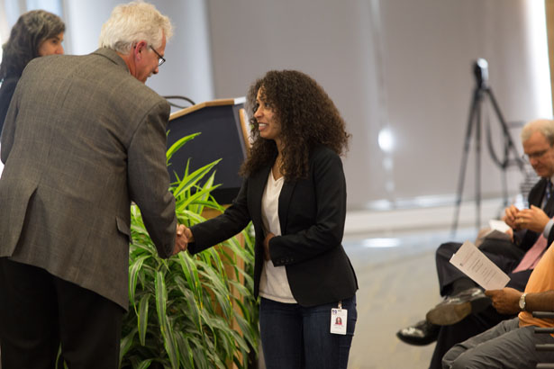 Tania Silvas, of the Schiffer lab, is congratulated by Dr. Carruthers.