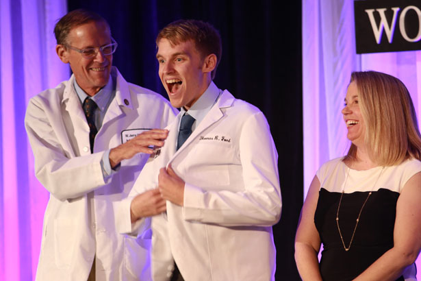“It fits!” Thomas Ford of Blackstone House proudly dons his white coat.