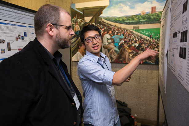 Ting-Hao Huang, right, a GSBS student in neurobiology, makes a point to Sean Ryder, PhD, associate professor of biochemistry & molecular pharmacology during the poster session.