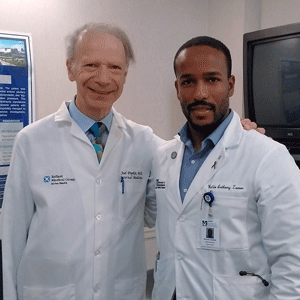 Aspiring dermatologist Waldo Zamor, SOM’16 (right), is pictured with Joel Popkin, MD, who invited Zamor to deliver a presentation on yaws. 