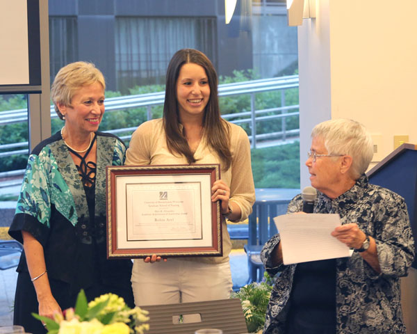Professor emeritus Mary Kay Alexander, EdD (right), presents the award named after to her to Robin Arel, with Dean Vitello.
