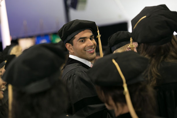 SOM graduate Jacob Koshy lines up to cross the stage and receive his degree.