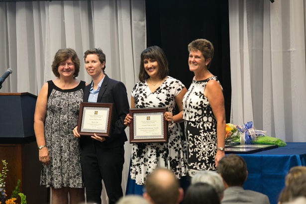 Students Sarrin List, second from left, and Sonali Gandhi accept Community Engagement Awards from Cheryl Killoran and Dr. Terrill.