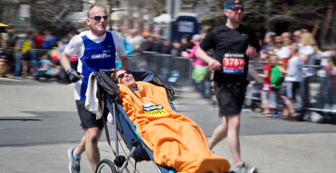 Chris Benyo pushes his wife Denise DiMarzo, who has ALS, up Heartbreak Hill during the 2014 Boston Marathon. (Photo courtesy of Sue Rothberg)
