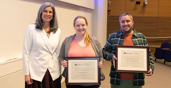 (L to R) Mary Ellen Lane, PhD, presents the Faculty Award for outstanding contributions to trainee mentoring and/or professional advancement by a postdoctoral associate to Rebecca Beiter, PhD, and Pablo Gimenez Gomez, PhD.  