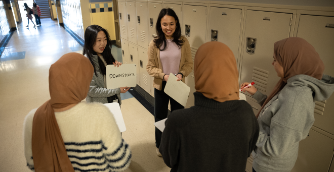 Medical students Jennifer Jaien Fung and Angelina Cicerchia instruct ESL students at North High School