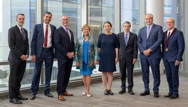 Chancellor David McManus (far left) and Terence R. Flotte, MD (far right) pose for a photo with the newly endowed professors, Samir Malkani, MD; Edwin D. Boudreaux, PhD; Johanna M. Seddon, MD, ScM, FARVO, FASRS; Jennifer Wang, MD; Andrew R. Tapper, PhD; and David Michael Dosa, MD, MPH