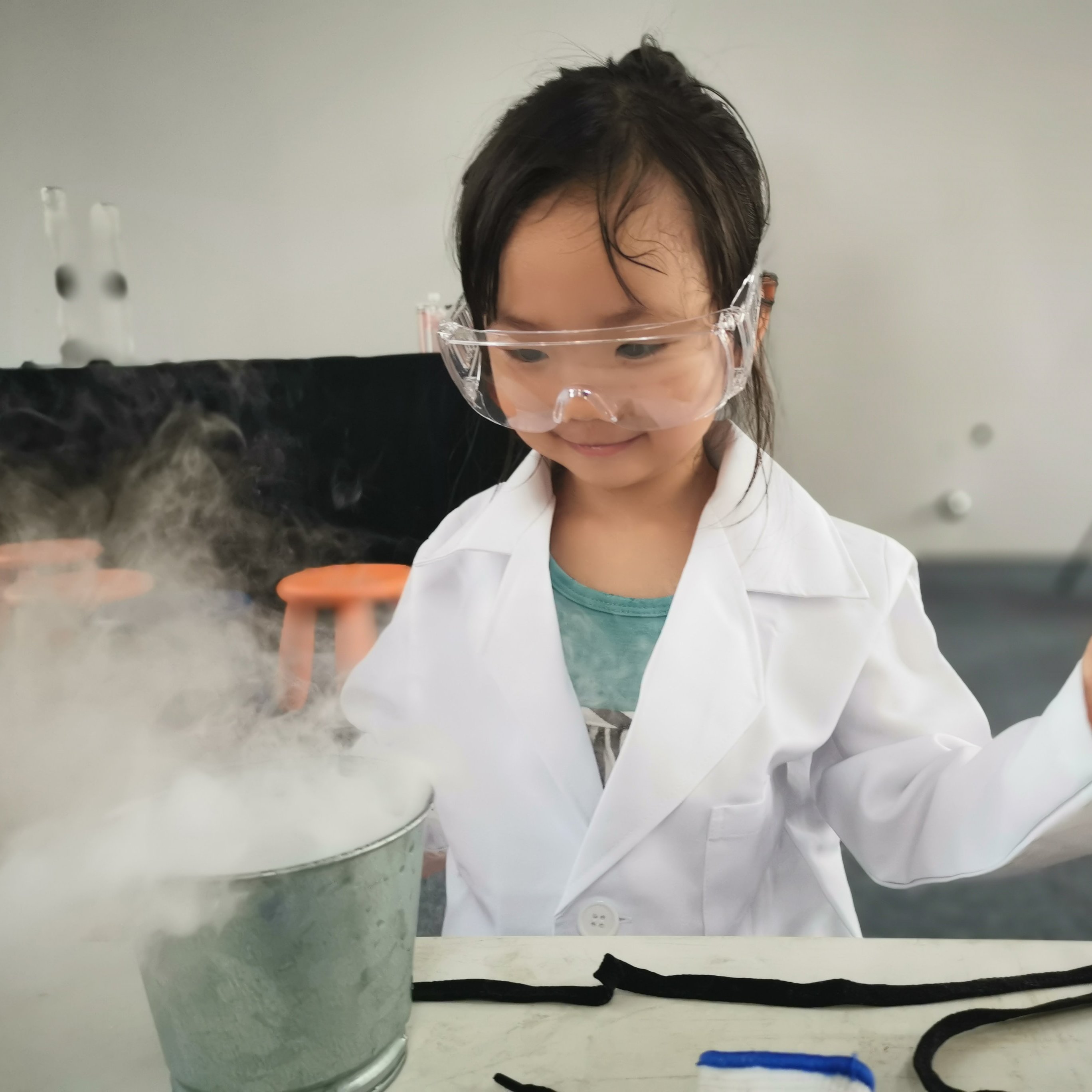 Child doing an experiment with dry ice. 