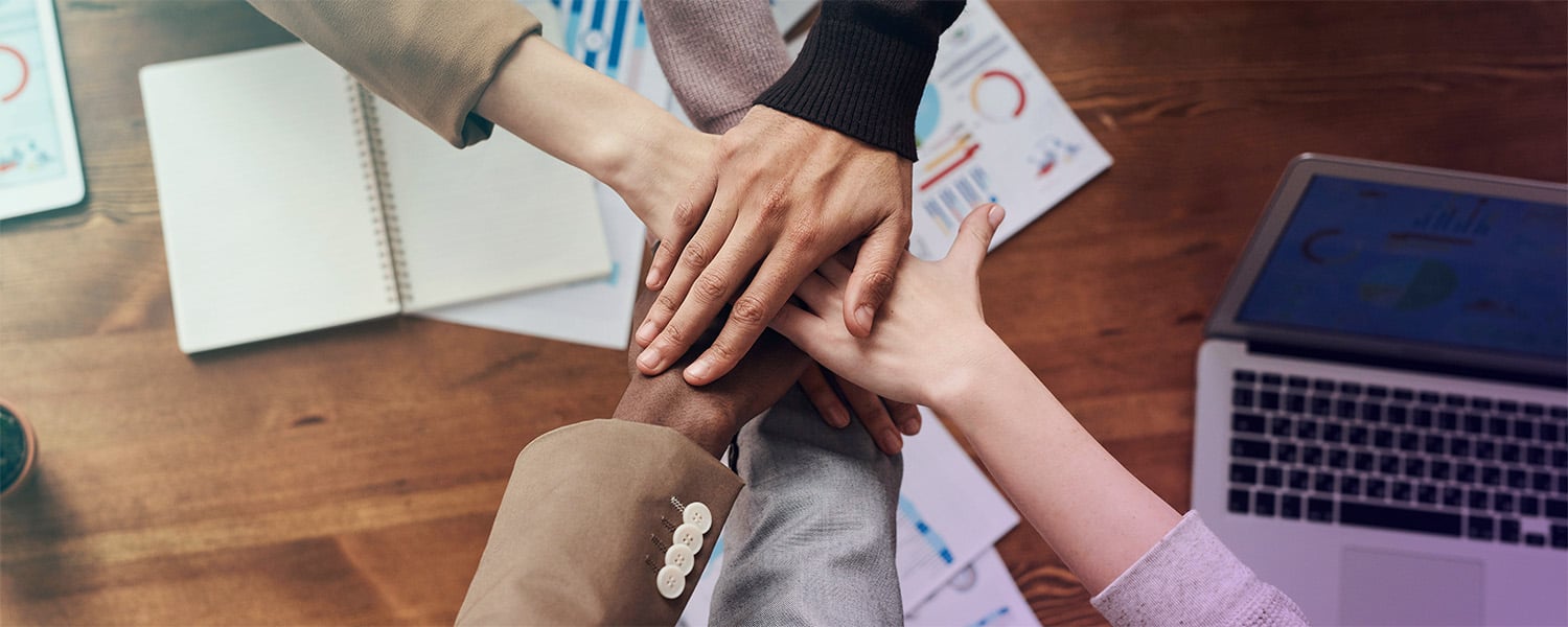 People with hands together in the center, concept of teamwork
