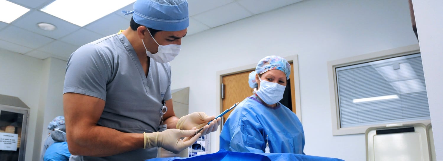 Doctor and assistant prepping for surgery