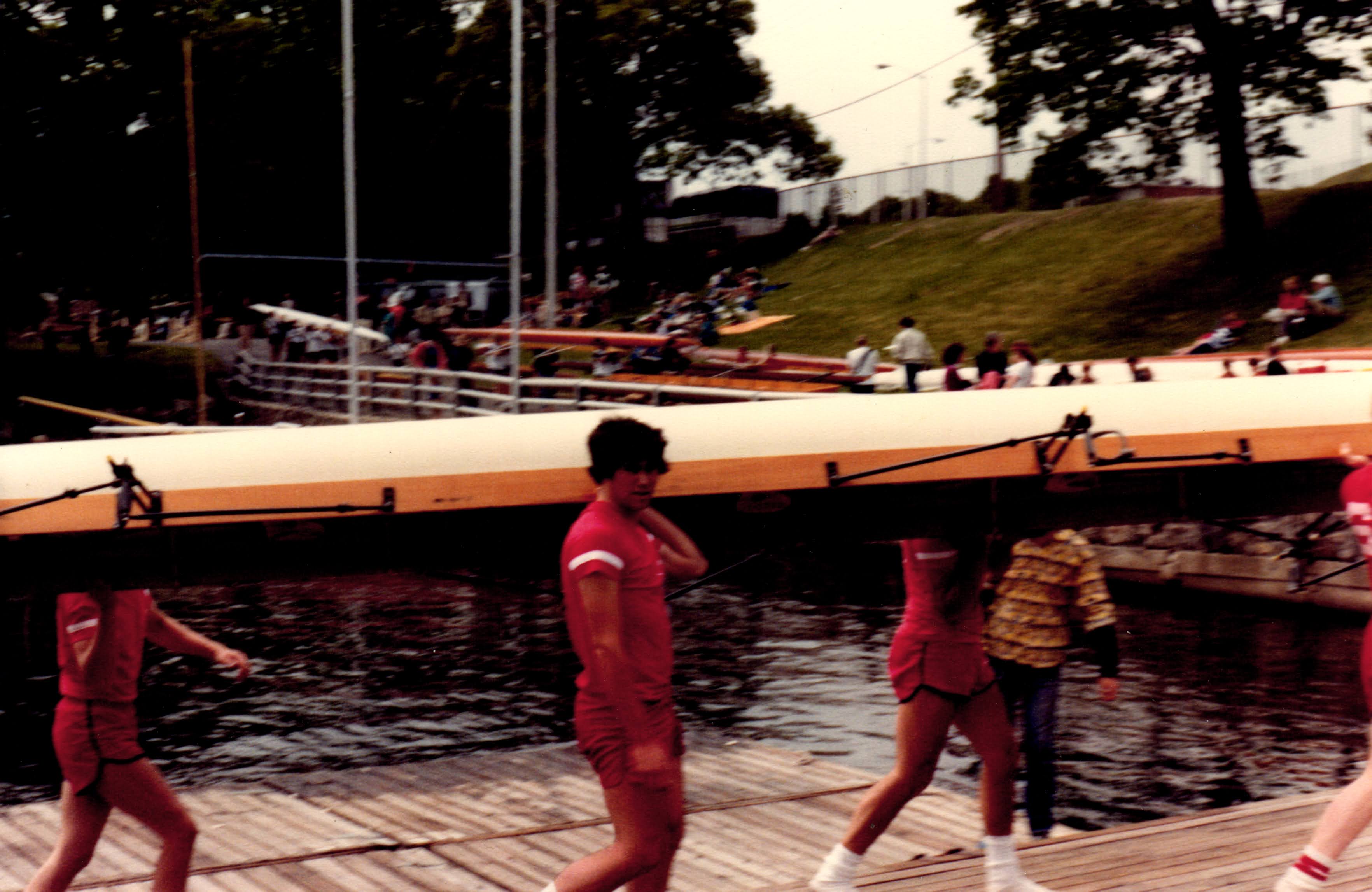 Michael holding a boat with his high school crew team