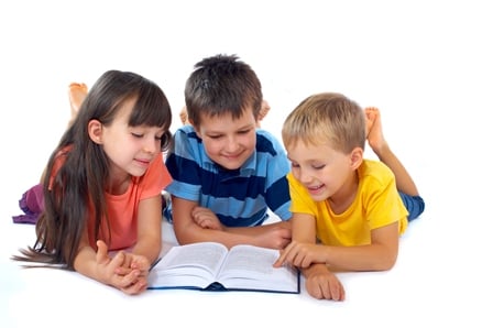 children reading a book together