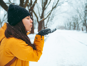 Woman blowing snow