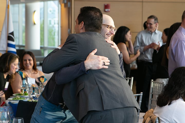 Alumni embracing at Reunion 2025.