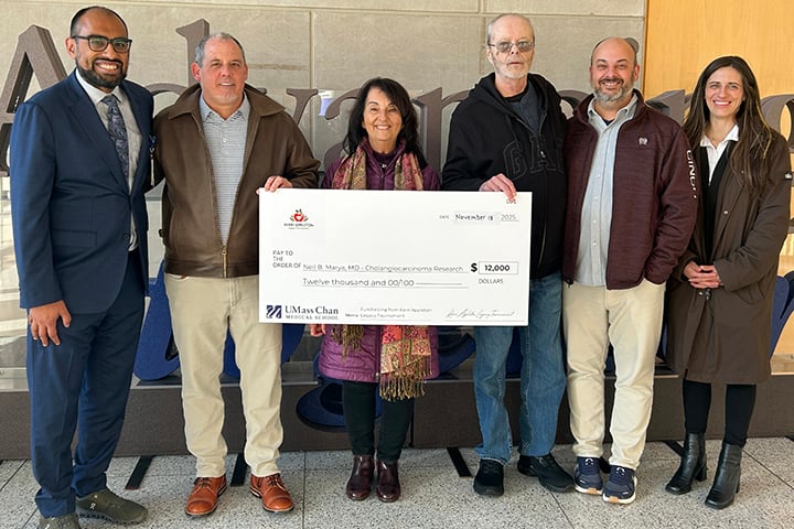 Kevin Brisette, second from left, joined by Kerri Appleton’s parents, brother and a close friend, presents an honorary check to Neil Marya, MD, first from left.