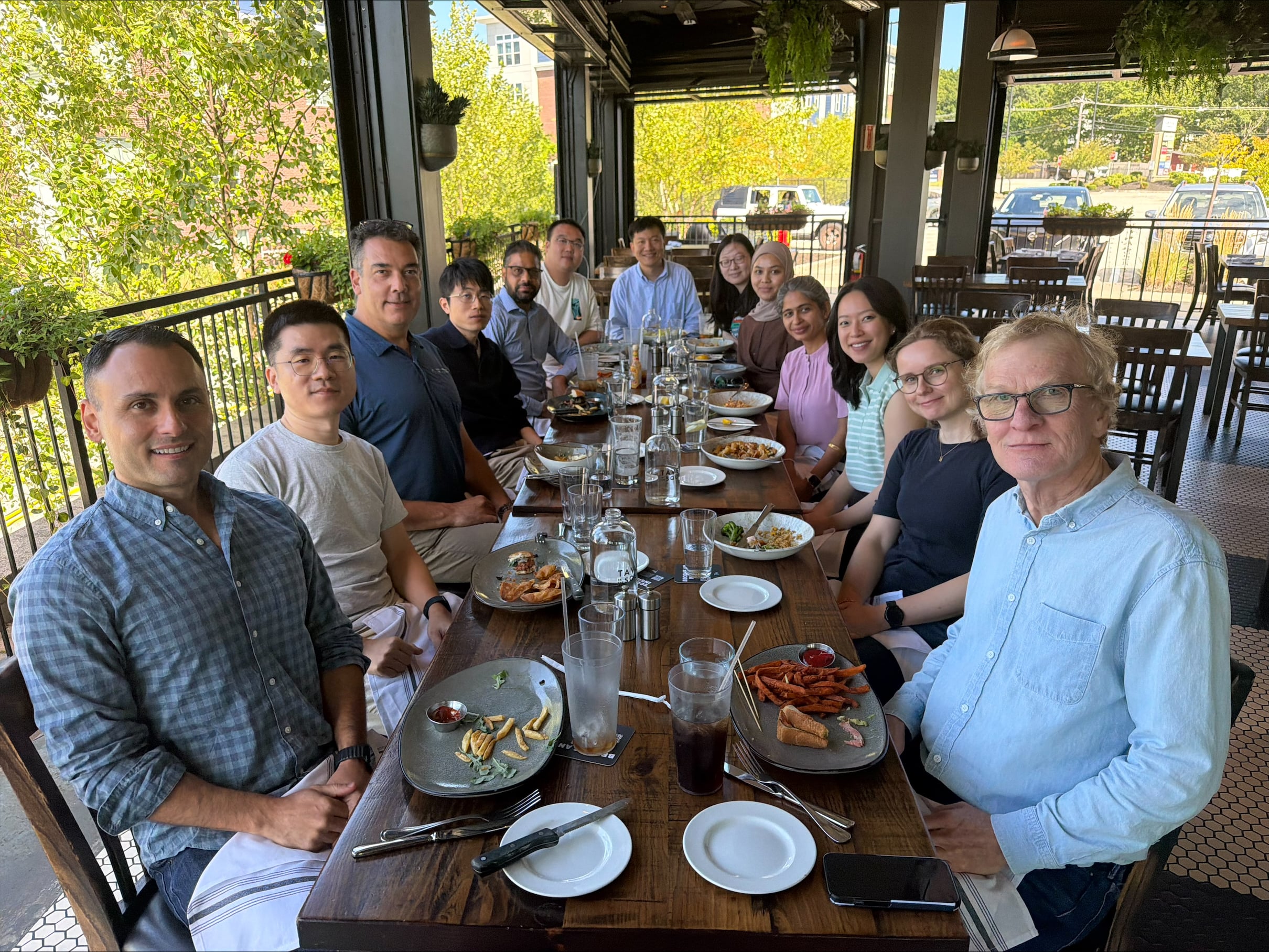 Members of the Gregory Lab gathered around a table eating lunch.