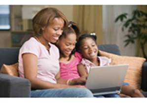 Image of mother & girls looking at computer