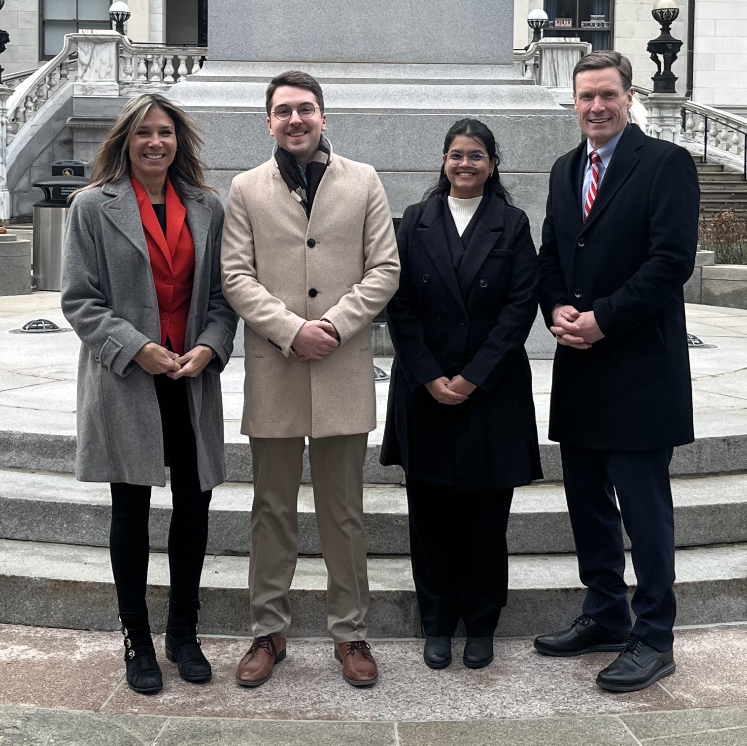 Gina Vincent, Spencer Lawson, Namita Railkar and Commissioner Jenkins in front of MA Statehouse