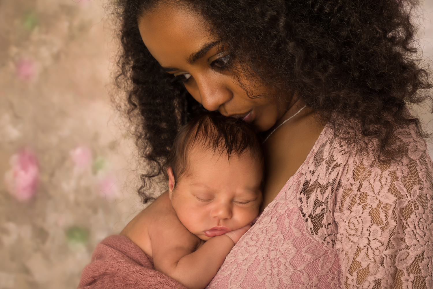 black mother looking worried while holding her infant