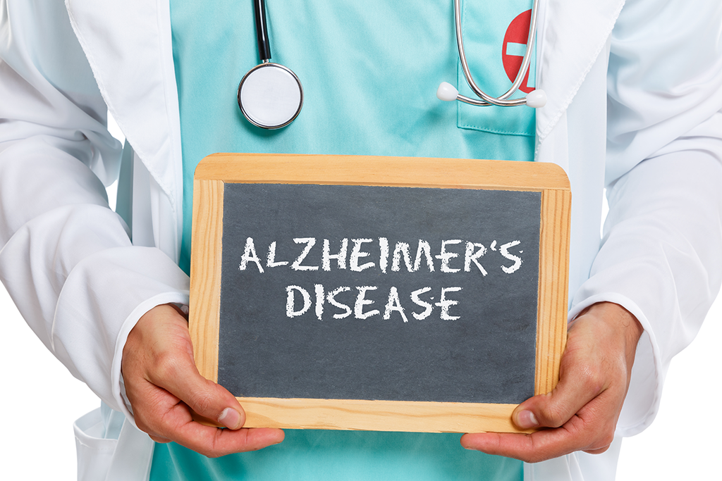 Picture of a physician holding a sign reading Alzheimer's Disease