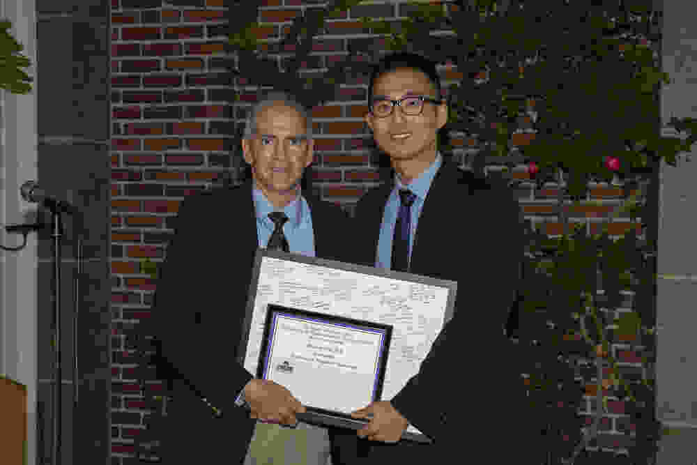 Dr. Makris congratulates graduating resident Dr. Heesop Shin