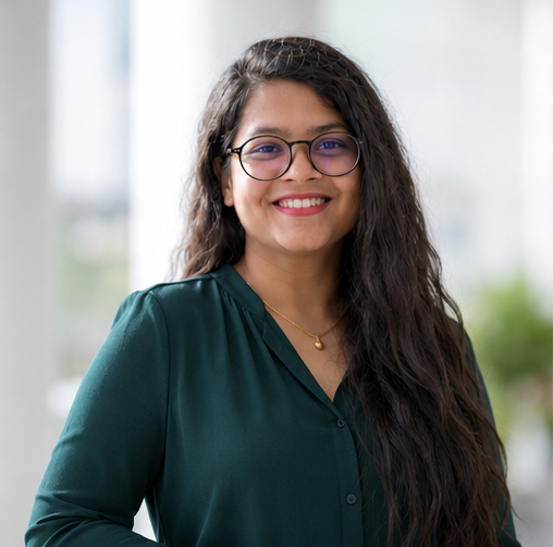 indian woman with long dark wavy hair and glasses