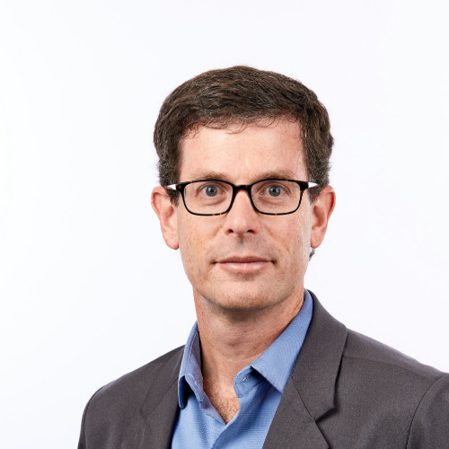 white middle aged man with dark hair and glasses