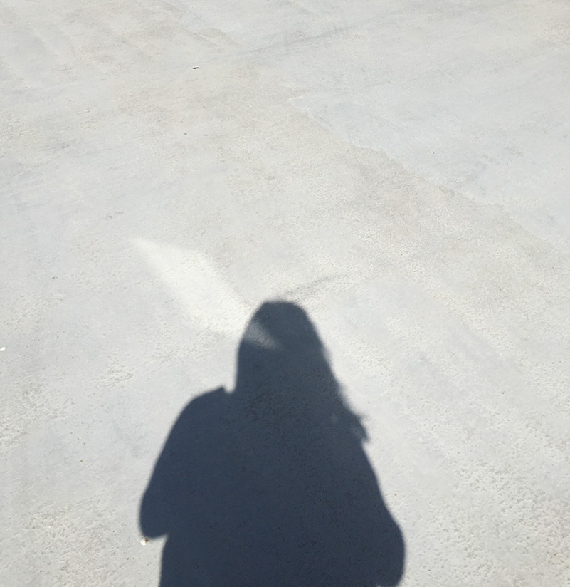Shadow of person on pavement