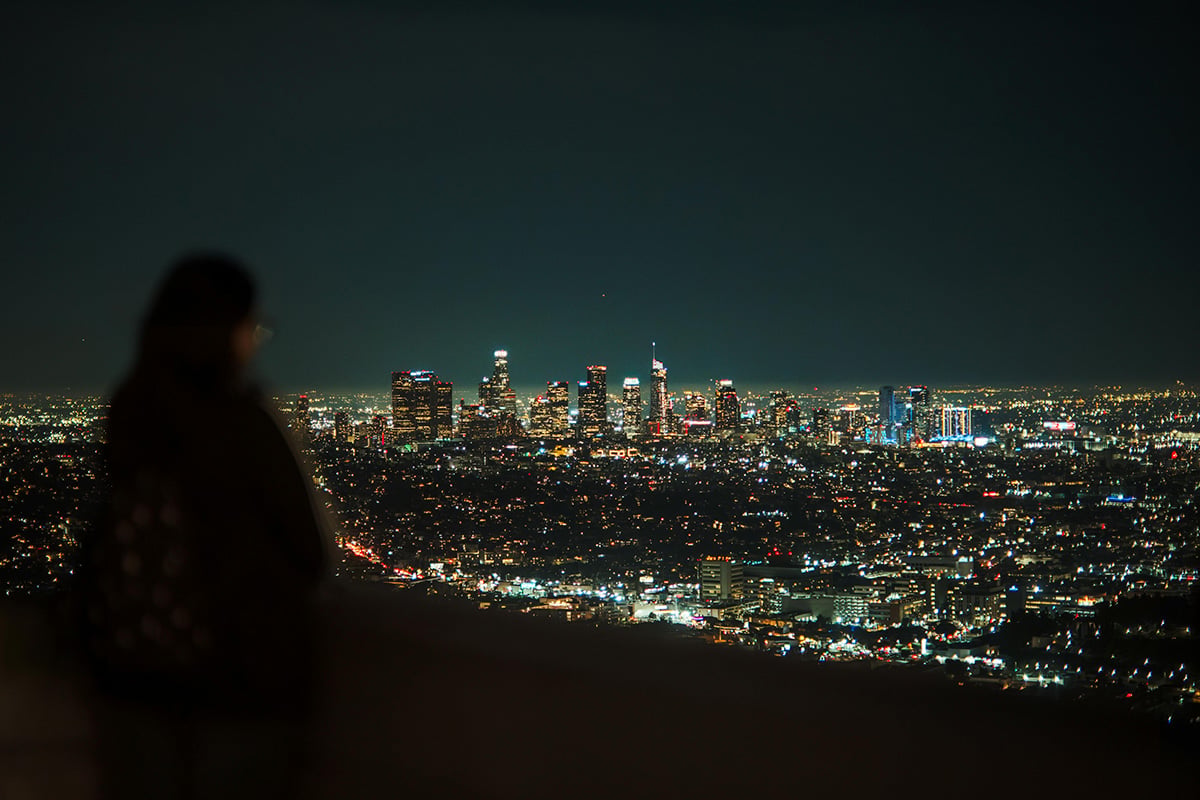 woman overlooking city at night