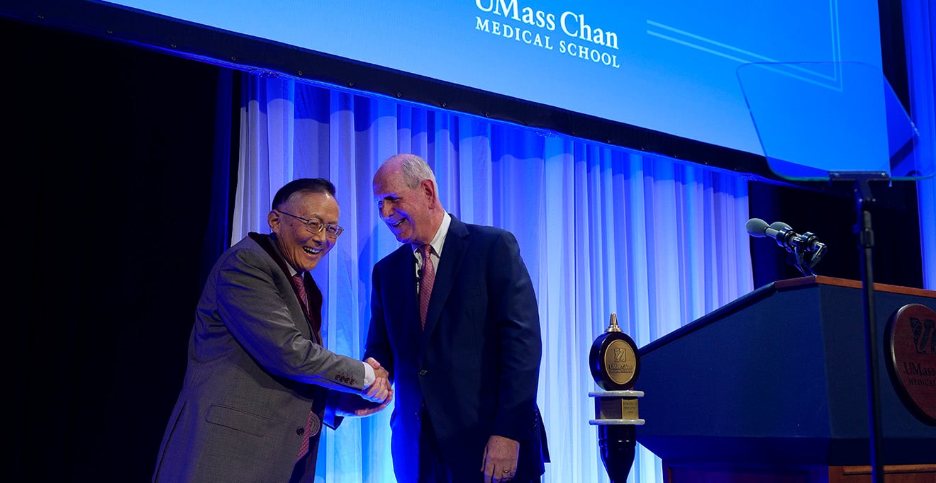 Guangping Gao, PhD, shares a laugh with Chancellor Michael F. Collins after receiving the Chancellor’s Medal for Distinguished Scholarship 
