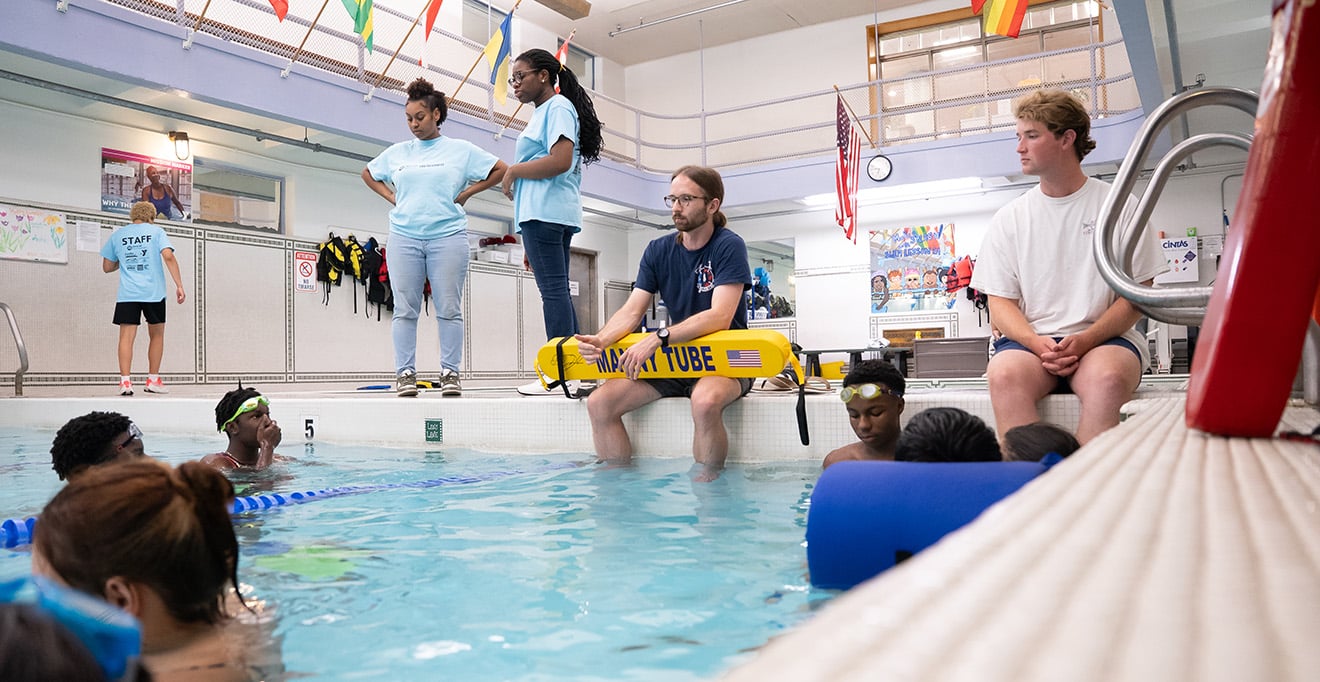  Medical student Michael Bedard (center) presents how to use a Manny Tube, a safety floatation device