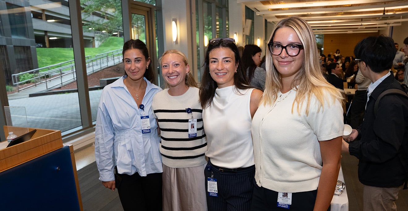 Medical students Carlin Stewart, Sydney Hall, Teodora Misic and Nicole Gaykova pose for a photo during the orientation breakfast. Gaykova, of Westwood, wants to stay in and serve Massachusetts residents. 