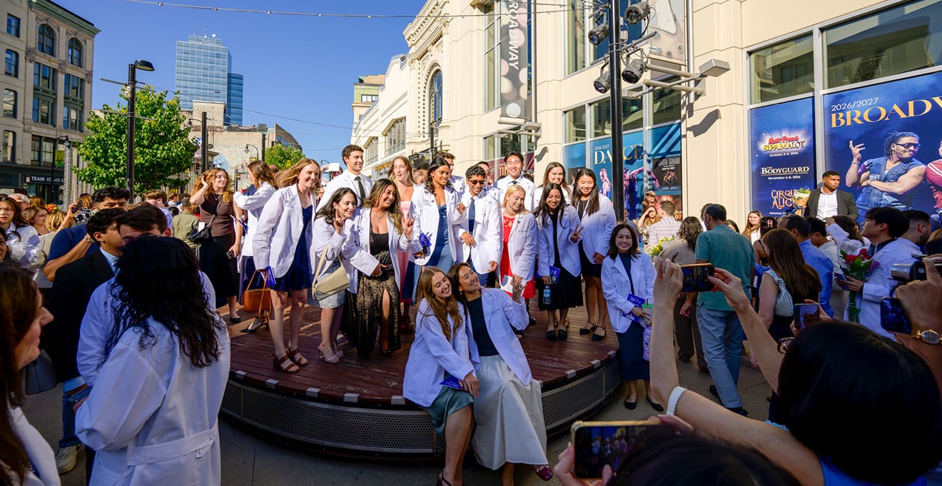 Medical students wearing their white coats outside of the Hanover Theater