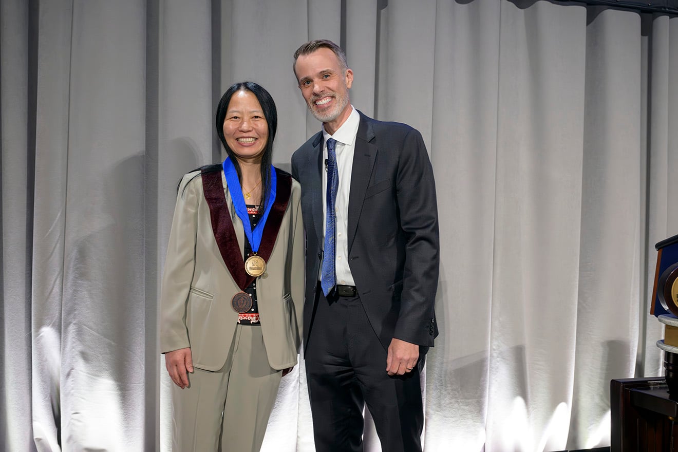 Zhiping Weng, PhD, recipient of the Chancellor&rsquo;s Medal for Distinguished Scholarship stands with Chancellor David McManus