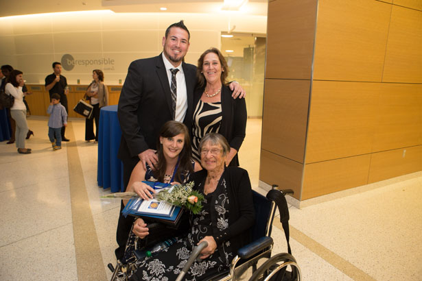 Graduate Entry Pathway student Desiree King is congratulated by her great aunt, Dr. Florence Hood (seated), her brother, Richard King (back, left), and her mother, Jeanne Clarke.