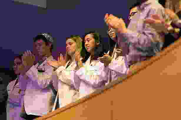 Medical students take in the Convocation proceedings from the balcony of the Albert Sherman Center auditorium.