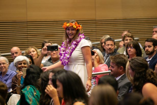Christina Cordray, a Hawaii native, recites a Hawaiian chant meant to grant wisdom as she processes with her classmates into the ceremony. She said the chant was a way to share her culture with the class.
