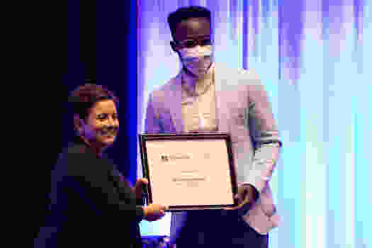 Reginald Sarpong accepts Clinical Excellence Award from Dr. Therrien.