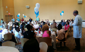 Chancellor Michael F. Collins talks with the 26 Worcester high school students and their supervisors and mentors at the close of the Building Brighter Futures With Youth summer jobs program.