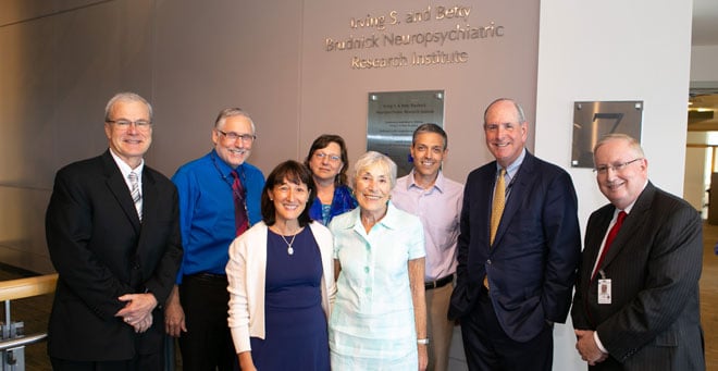 Shown here in the new location of the institute are: (front row, from left) Amy Brudnick Cerel and Betty Brudnick; (back row, from left) Terence R. Flotte, the Celia and Isaac Haidak Professor of Medical Education, executive deputy chancellor, provost and dean of the School of Medicine; Sheldon Benjamin, MD, interim chair and professor of psychiatry; Vivian Budnik, PhD, chair and professor of neurobiology ; Andrew Tapper, PhD, professor of neurobiology and director of the Brudnick Neuropsychiatric Research Institute; Chancellor Michael F. Collins; and Dr. Rothschild, professor of psychiatry.