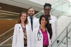 The first graduating class of UMass Chan’s BSN to DNP program is (from left) Hanna Roy, Shaun L’Esperance, Afsaneh Lomax and Anne Kiraithe.