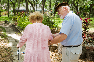 elderly couple walking outdoors