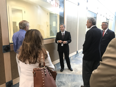 MassBiologics Deputy Director of Manufacturing Frank Fazio (center) leads a tour for local lawmakers of the MassBiologics SouthCoast facility.