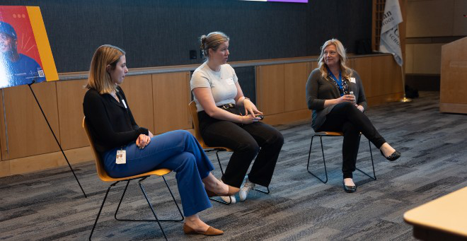 Photo of three people in chairs during a discussion panel