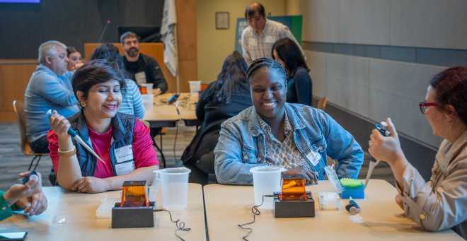 Photo of participants at a table during the lab activity at “What the Heck is BioTech?”